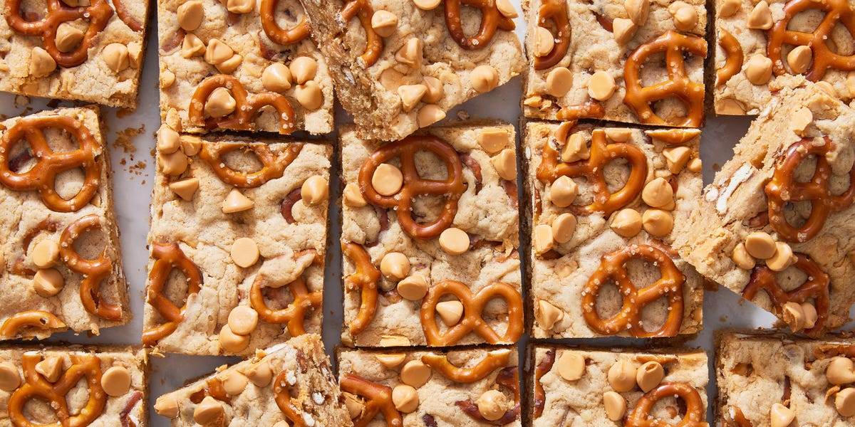 peanut butter pretzel butterscotch blondies cut up on a marble surface