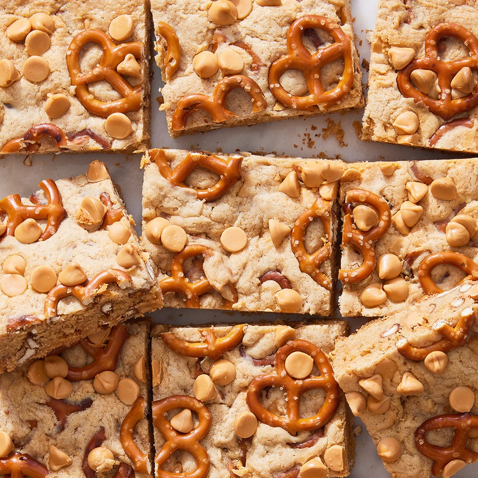 peanut butter pretzel butterscotch blondies cut up on a marble surface