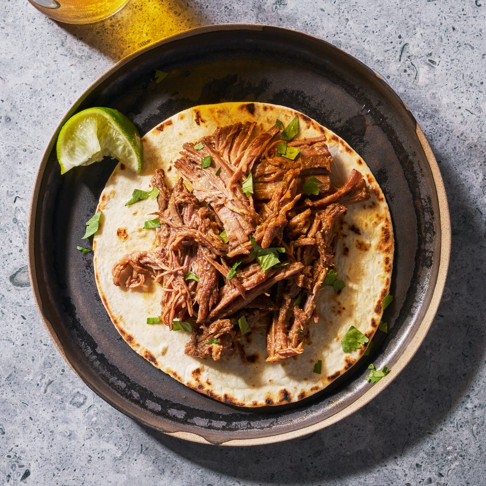 beef chuck roast seasoned with chili powder, cumin, scallion, and garlic then slow cooked until tender