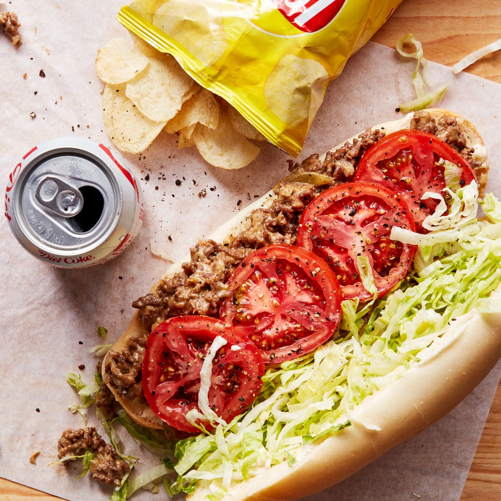 a bodega classic with seared adobo seasoned ground beef and chopped onions, gooey american cheese, and lettuce, tomato, mayo on a soft hero roll