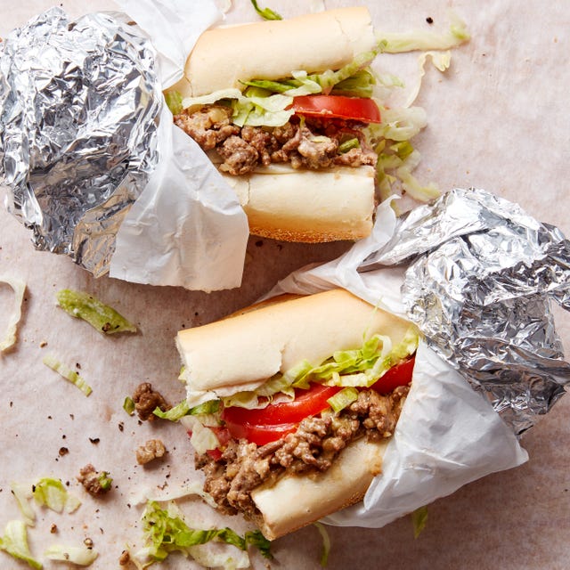 a bodega classic with seared adobo seasoned ground beef and chopped onions, gooey american cheese, and lettuce, tomato, mayo on a soft hero roll