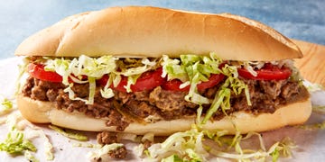 a bodega classic with seared adobo seasoned ground beef and chopped onions, gooey american cheese, and lettuce, tomato, mayo on a soft hero roll