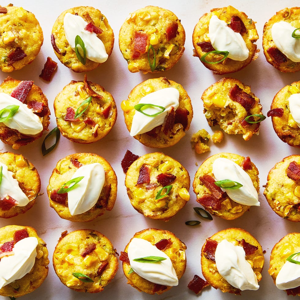 loaded cheesy corn bites topped with sour cream, sliced scallions, and bacon