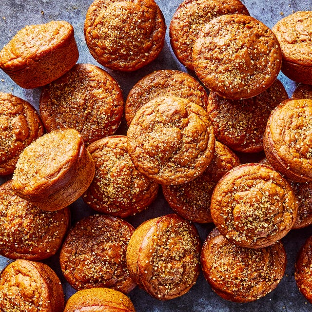 a pile of pumpkin muffins topped with coarse sugar