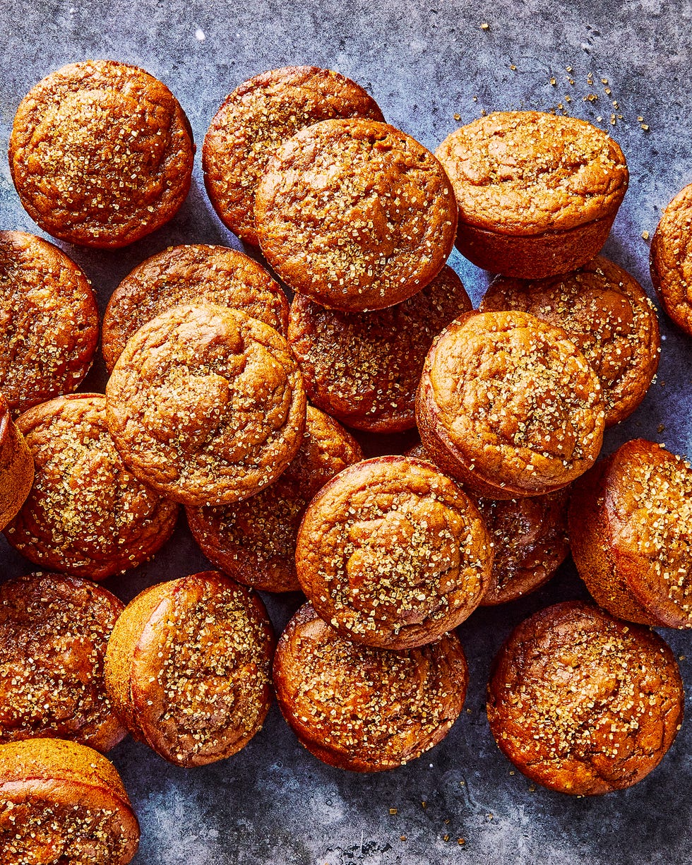 a pile of pumpkin muffins topped with coarse sugar