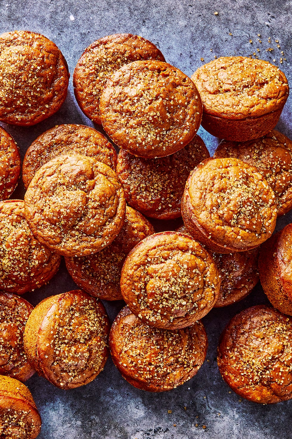 Pumpkin Muffins a pile of pumpkin muffins topped with coarse sugar
