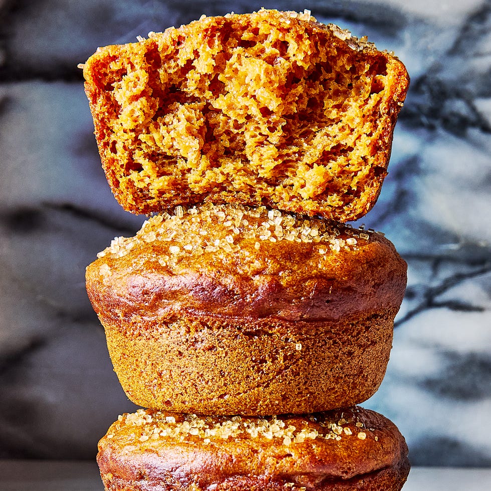 a pile of pumpkin muffins topped with coarse sugar