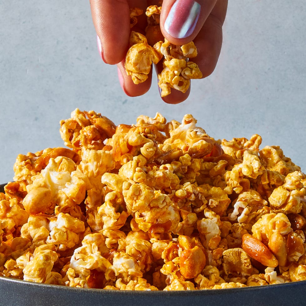 caramel sauce, honey, and roasted peanuts get tossed with popcorn and baked until crisp and crunchy