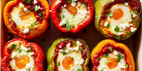 shakshuka stuffed peppers in a baking dish topped with cilantro and feta