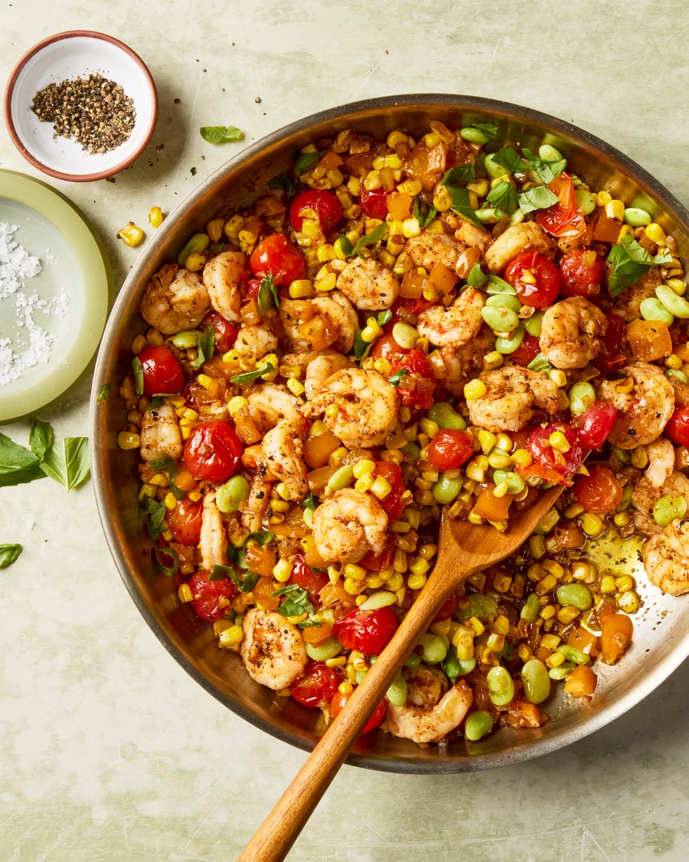 blistered tomatoes and charred corn tossed with onion, bell pepper, lima beans, and seared cajun spiced shrimp then topped with a flurry of torn basil