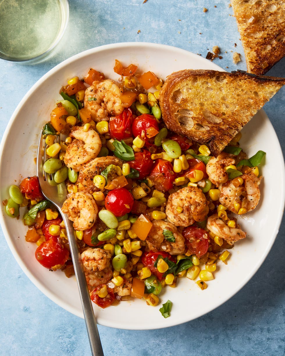 blistered tomatoes and charred corn tossed with onion, bell pepper, lima beans, and seared cajun spiced shrimp then topped with a flurry of torn basil