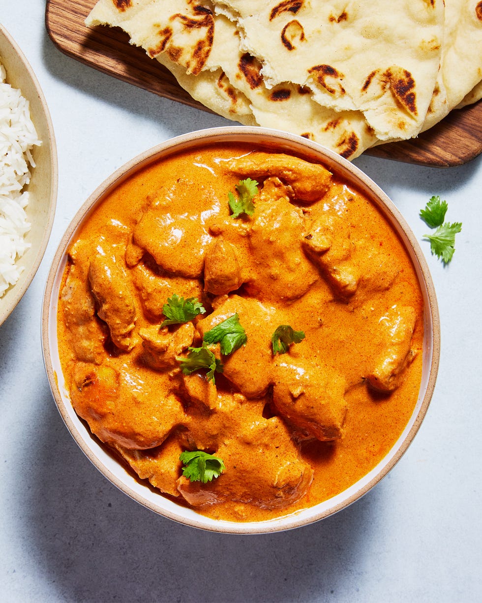 butter chicken in a bowl topped with cilantro