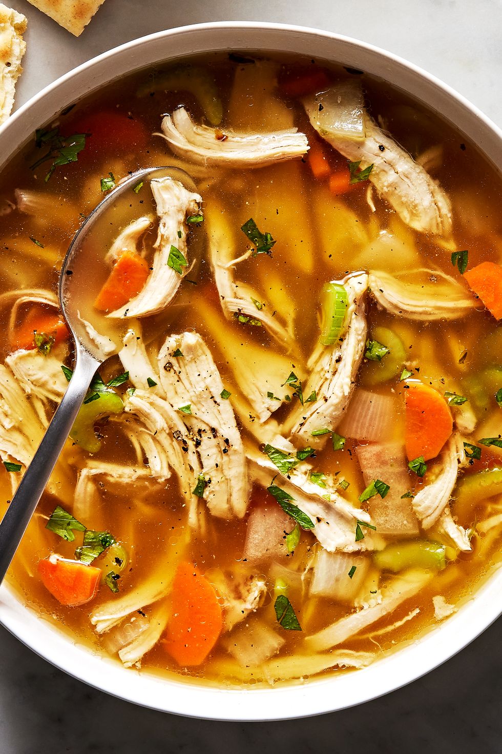 chicken soup in a bowl with saltines
