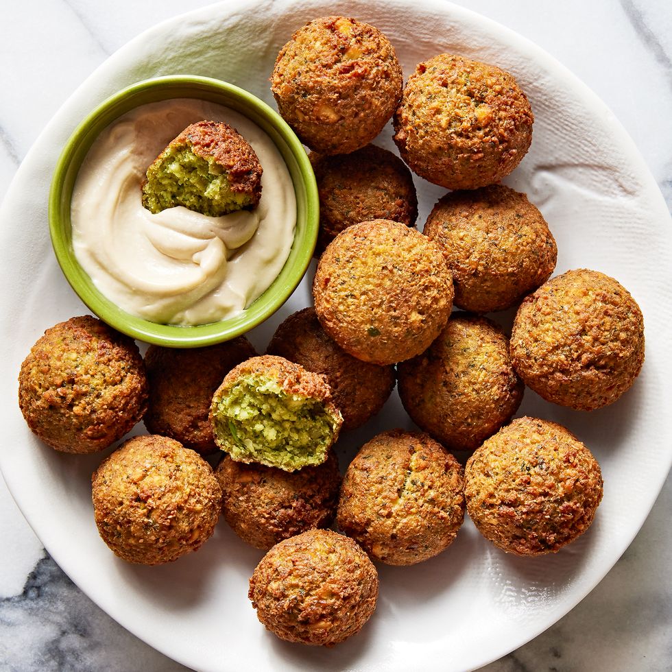 falafel in a bowl with a smaller bowl of tahini sauce