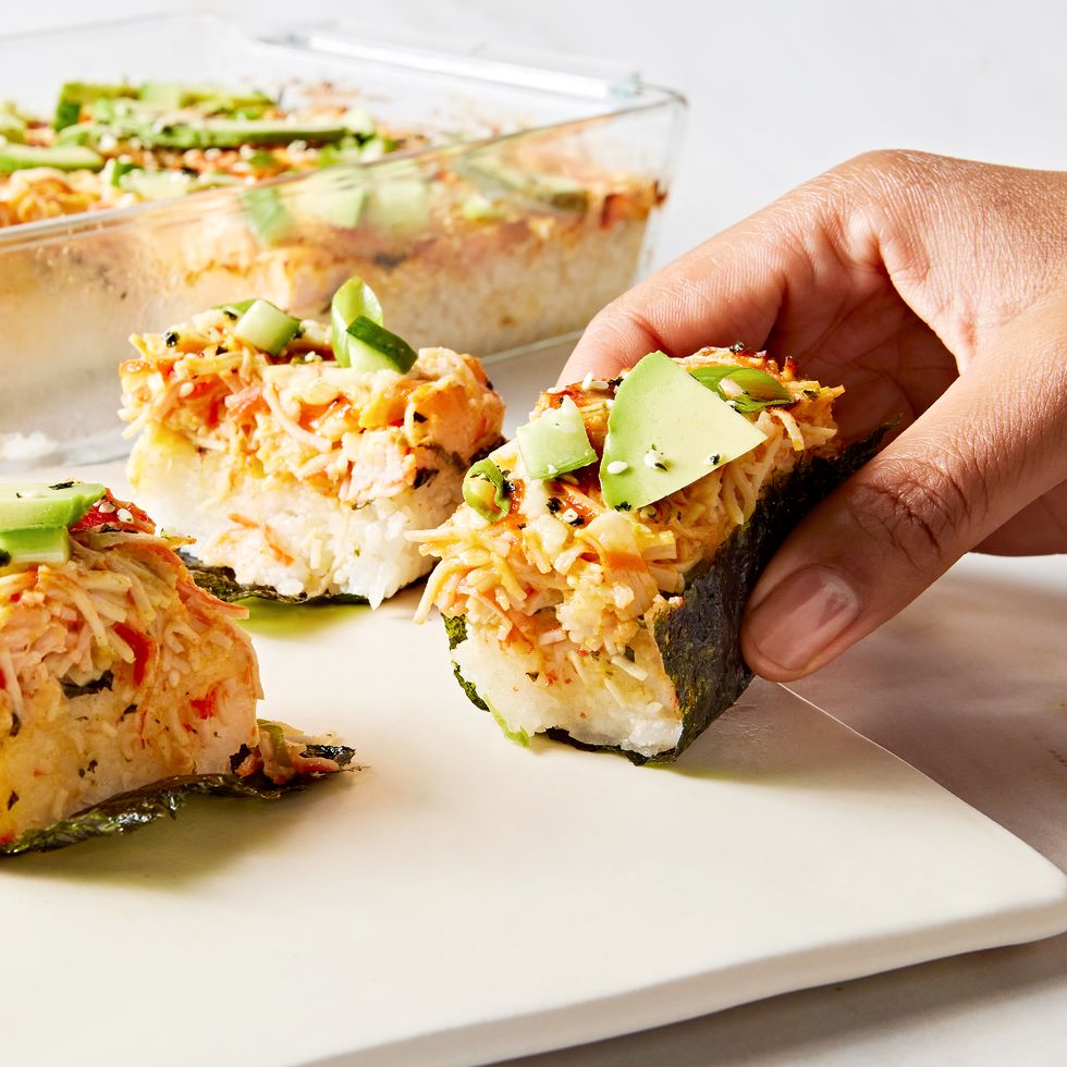 seasoned sushi rice and spicy chopped crab baked and topped with sriracha, kewpie mayo, avocado, cucumber, and furikake