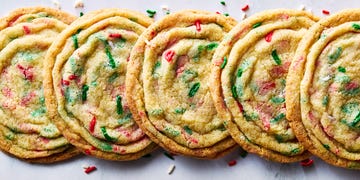 pan banging holiday confetti cookies on a white surface