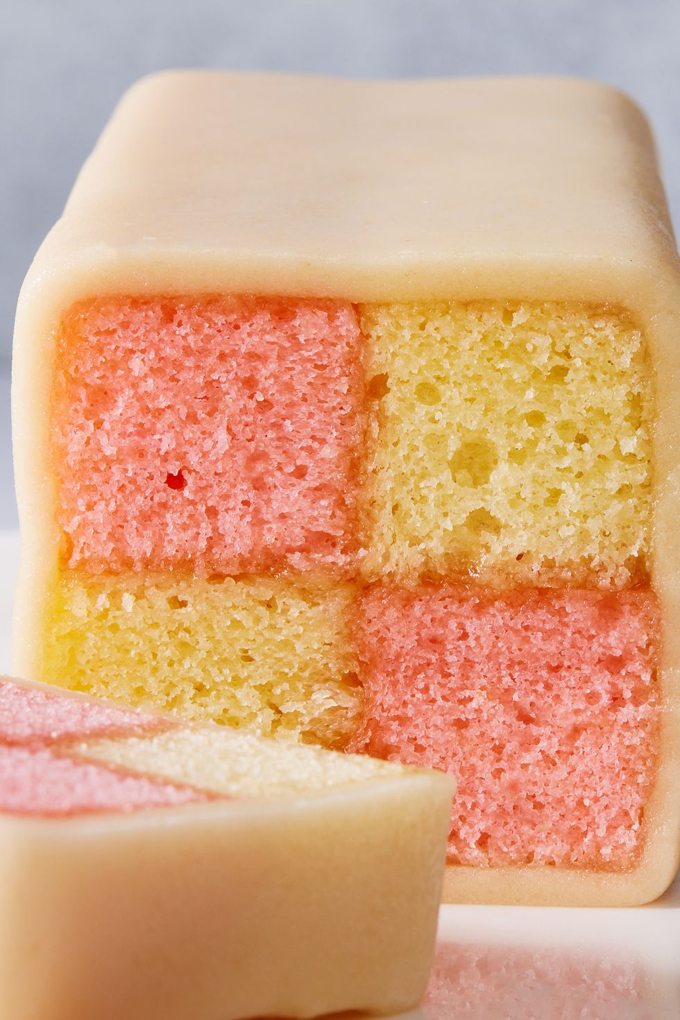 pink and yellow battenberg cake covered in marzipan