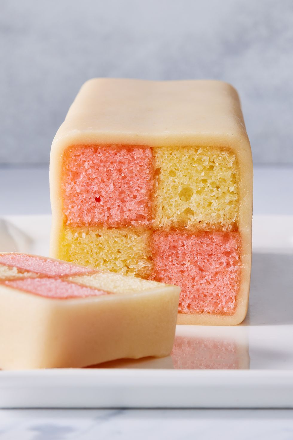 pink and white checked battenberg cake covered with marzipan