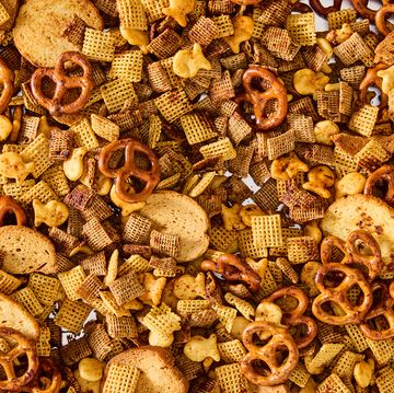 a bowl of homemade chex mix with pretzels, chex cereal, goldfish, and bagel chips