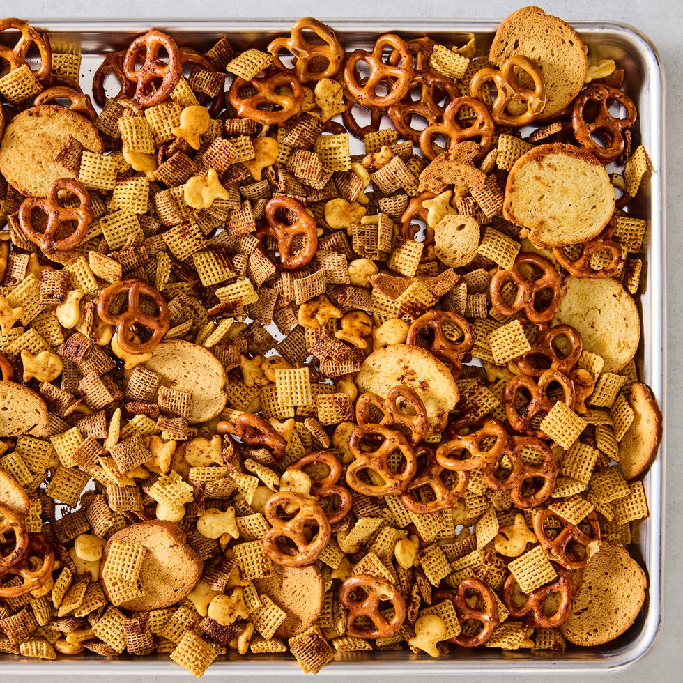 a bowl of homemade chex mix with pretzels, chex cereal, goldfish, and bagel chips