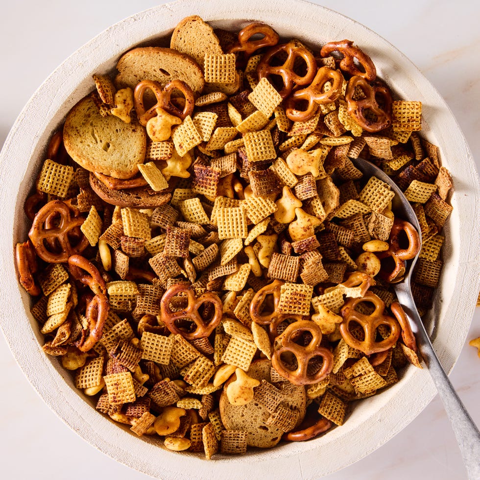 a bowl of homemade chex mix with pretzels, chex cereal, goldfish, and bagel chips