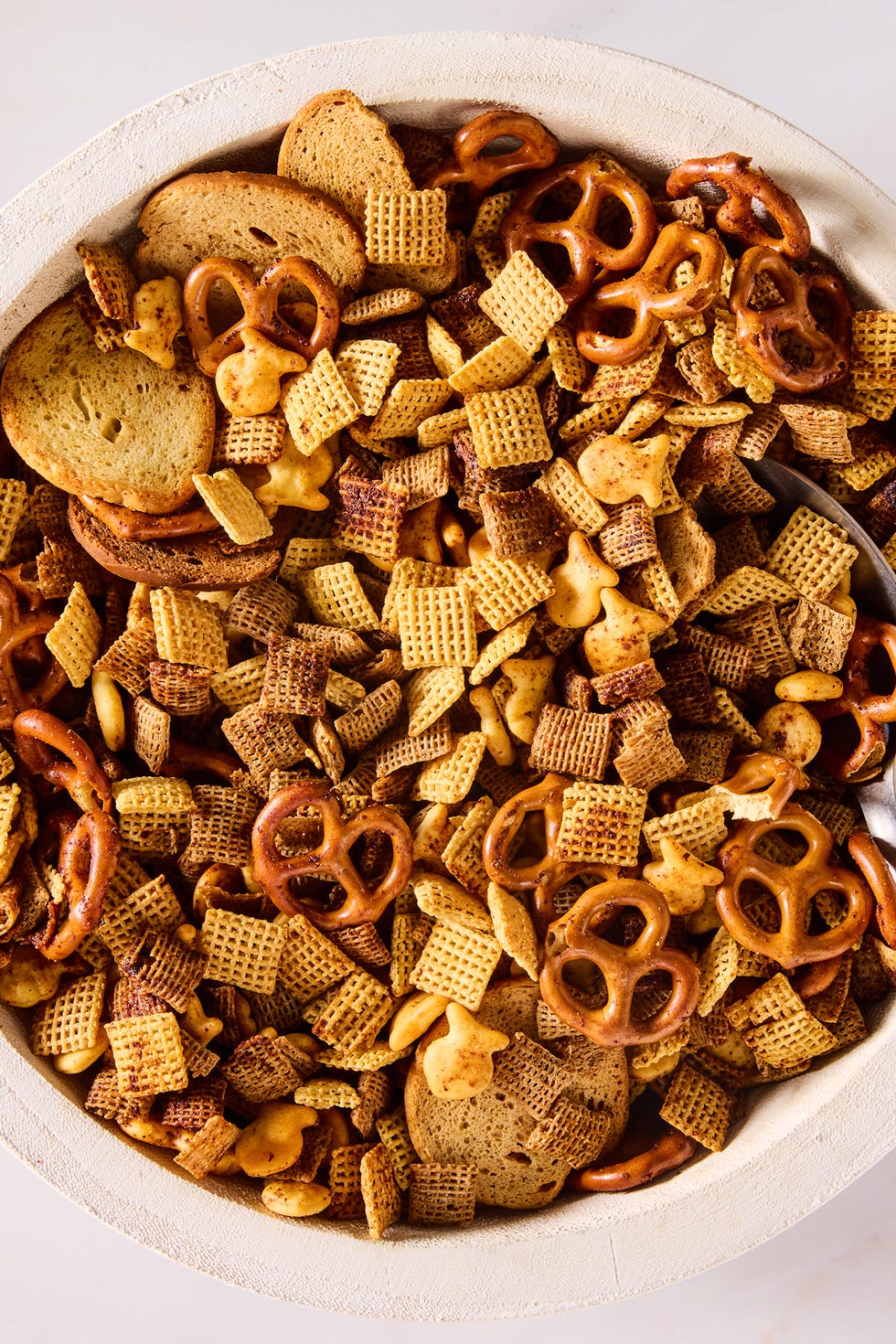Chex Mix a bowl of homemade chex mix with chex cereal, pretzels, goldfish, and bagel chips