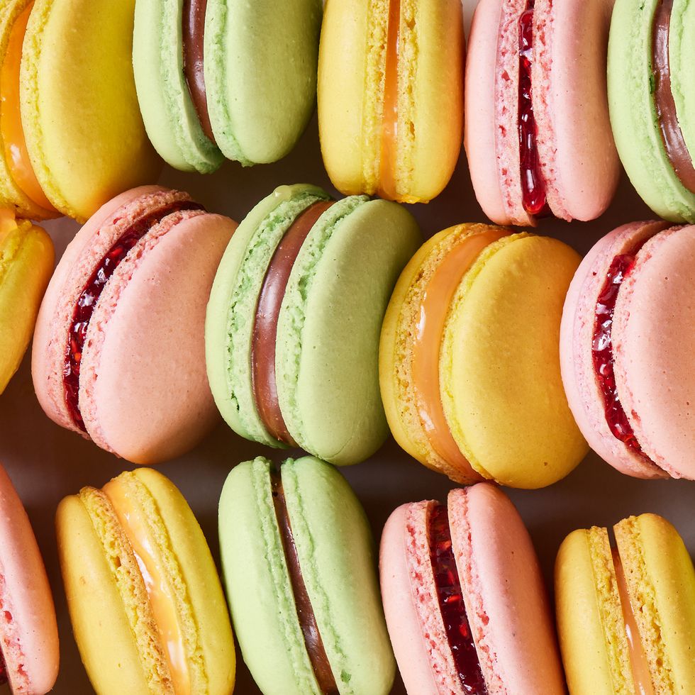 yellow, pink, and green macarons lined up together