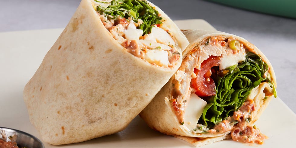 whole wheat wrap spread with parmesan herb mayonnaise and wrapped around chopped rotisserie chicken, creamy fresh mozzarella, spinach, and cherry tomatoes