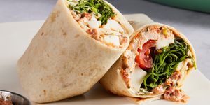 whole wheat wrap spread with parmesan herb mayonnaise and wrapped around chopped rotisserie chicken, creamy fresh mozzarella, spinach, and cherry tomatoes
