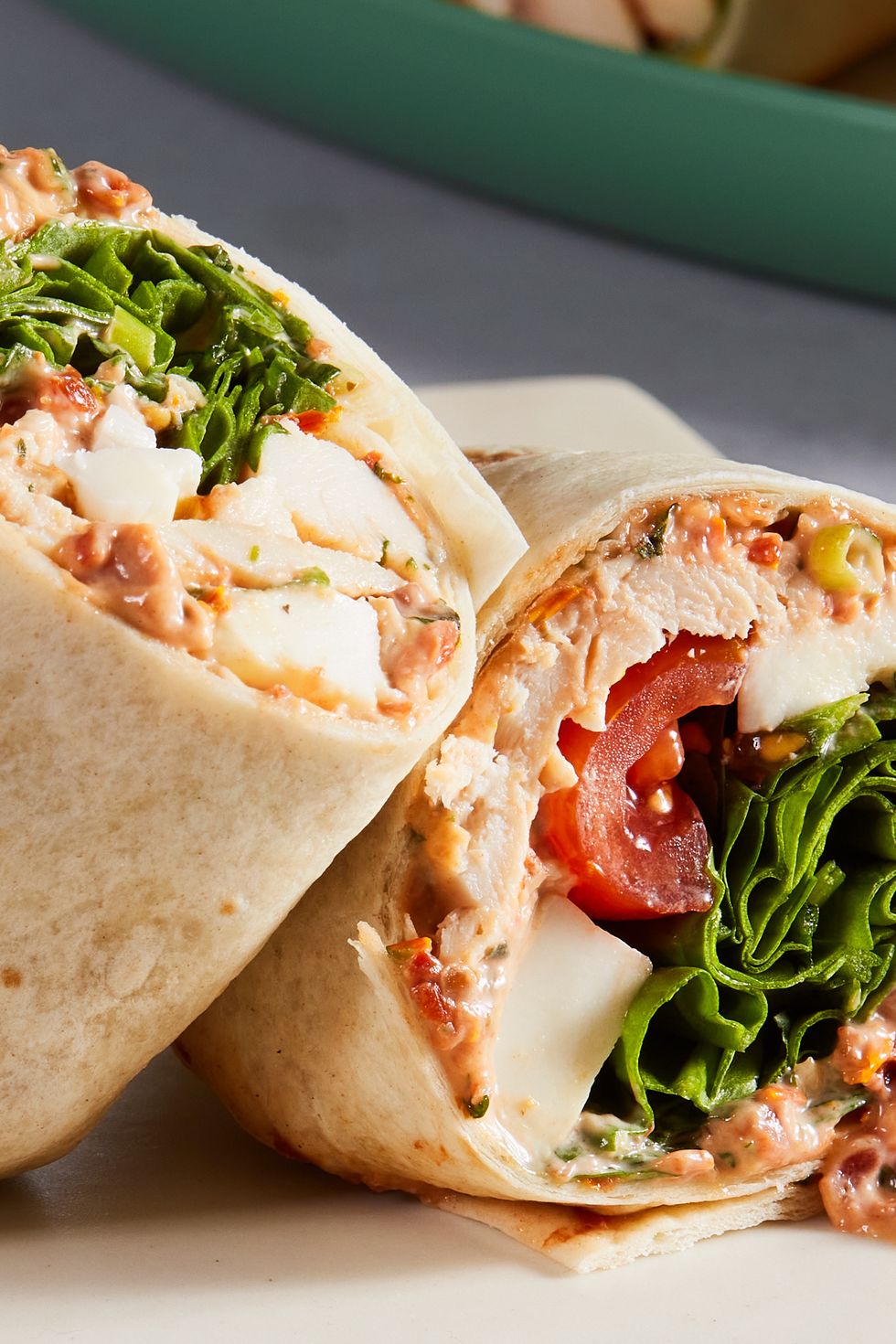 whole wheat wrap spread with parmesan herb mayonnaise and wrapped around chopped rotisserie chicken, creamy fresh mozzarella, spinach, and cherry tomatoes