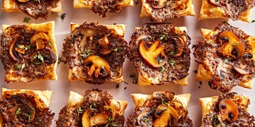 individual puff pastry squares topped with a cheesy mushroom duxelles, slices of roasted mushrooms, and fresh thyme