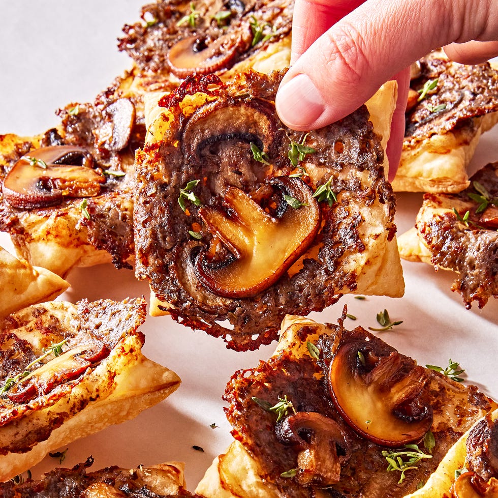 individual puff pastry squares topped with a cheesy mushroom duxelles, slices of roasted mushrooms, and fresh thyme