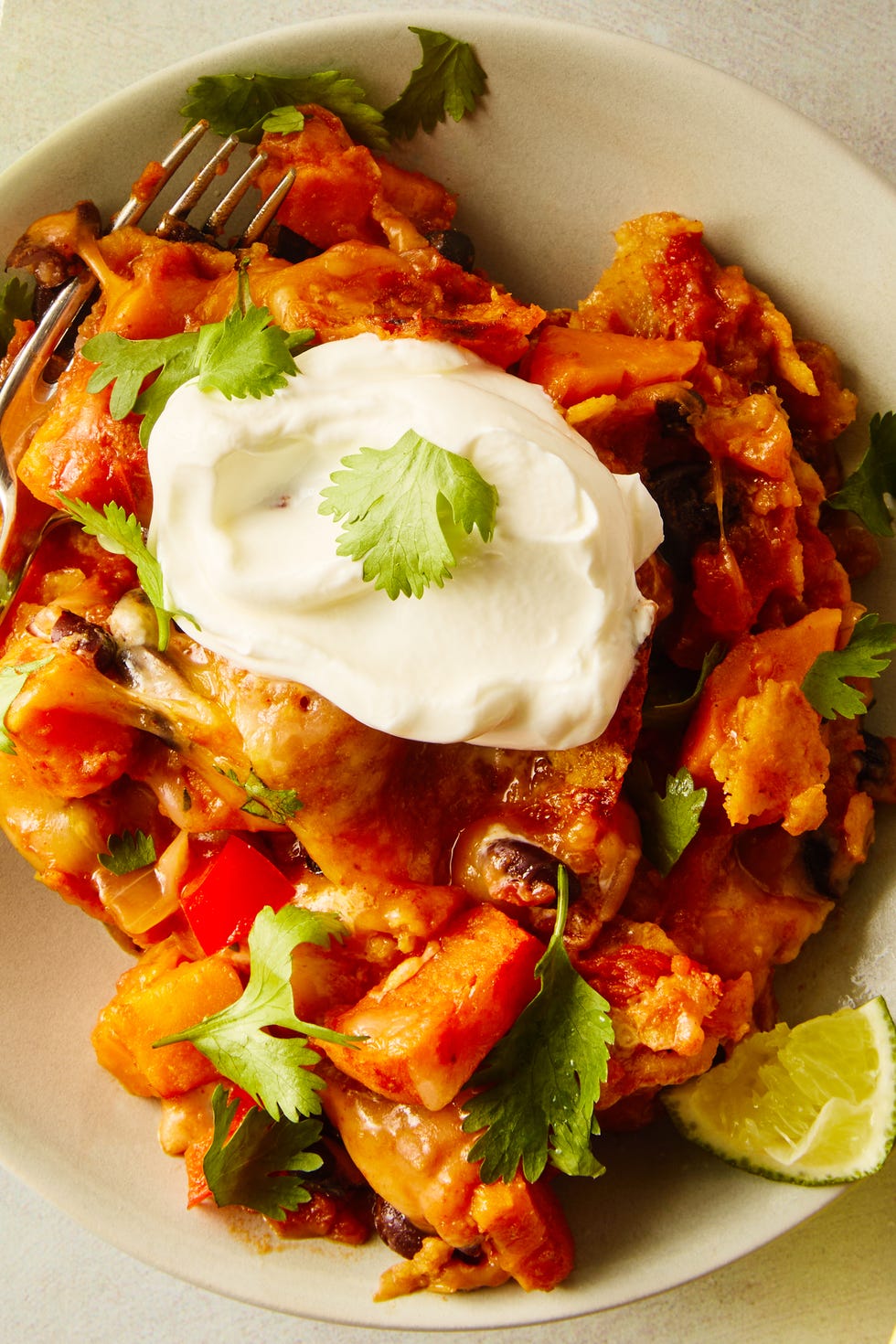Black bean sweet potato taco skillet black bean sweet potato taco skillet serving on a plate topped with sour cream and cilantro