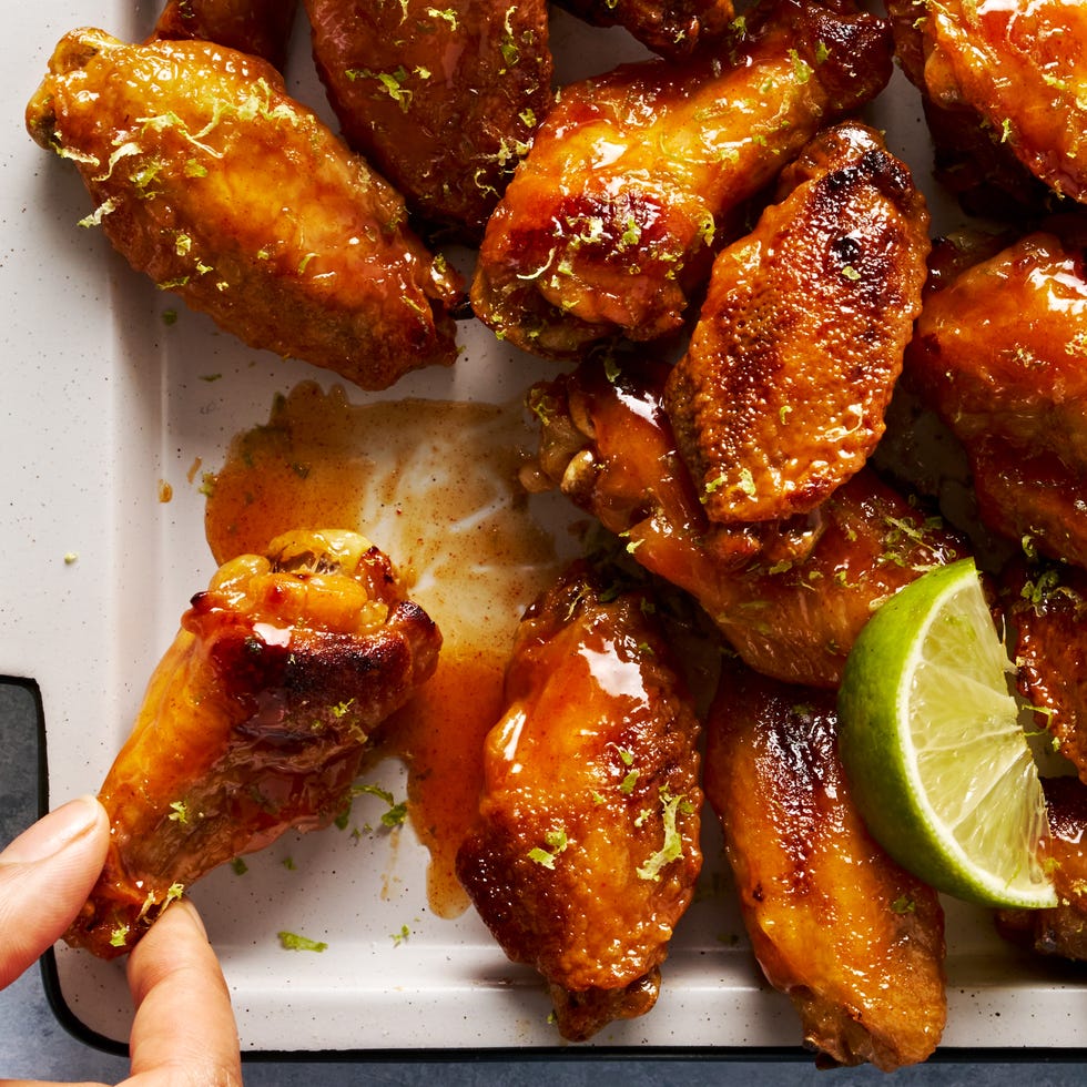 coconut lime chicken wings on a tray topped with lime zest