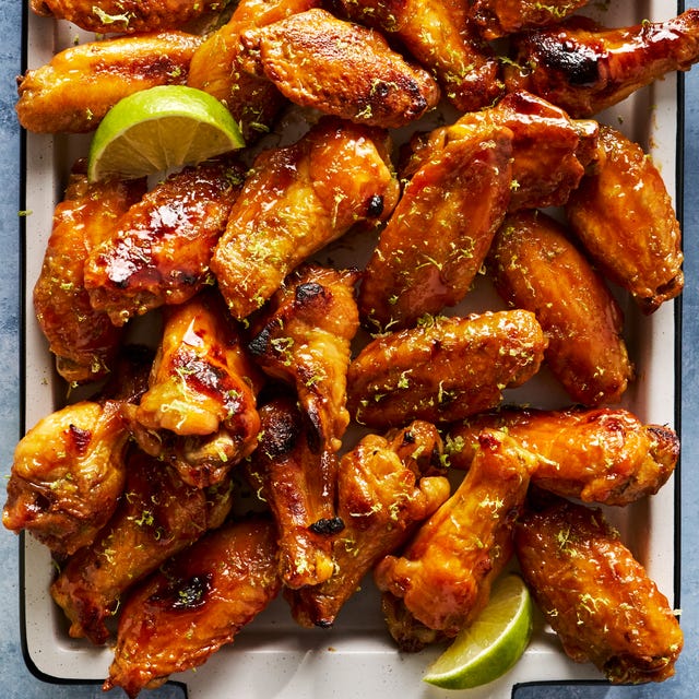 coconut lime chicken wings on a tray with lime wedges