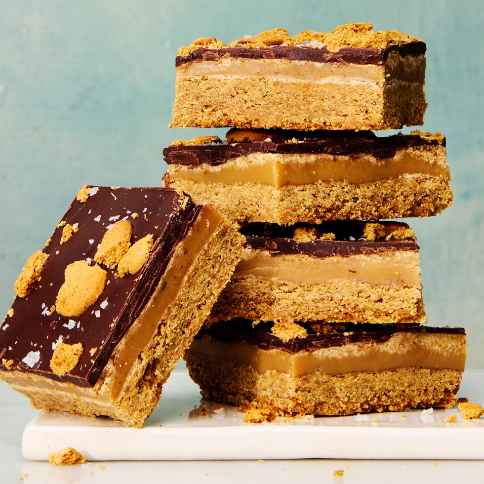 a stack of gingerbread millionaire shortbread bars