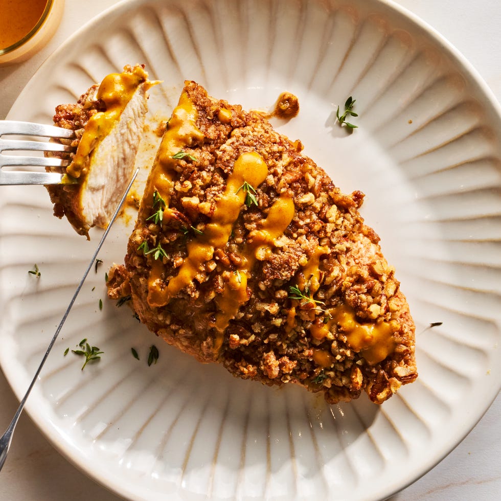 chicken cutlets are tossed in a punchy and herby maple mustard sauce, then topped with chopped pecans and baked to juicy, crunchy perfection