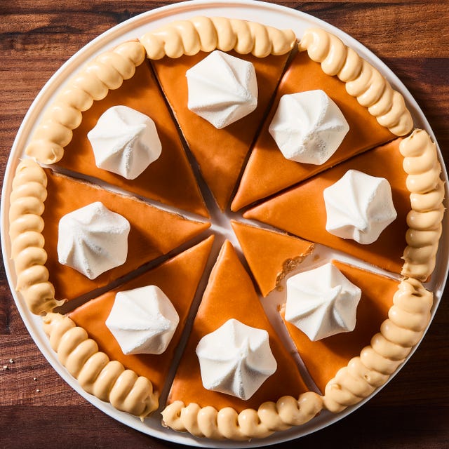 Pumpkin Pie Sugar Cookies triangular spiced shortbread cookies coated in orange icing, beige frosting, and a vanilla meringue cookie
