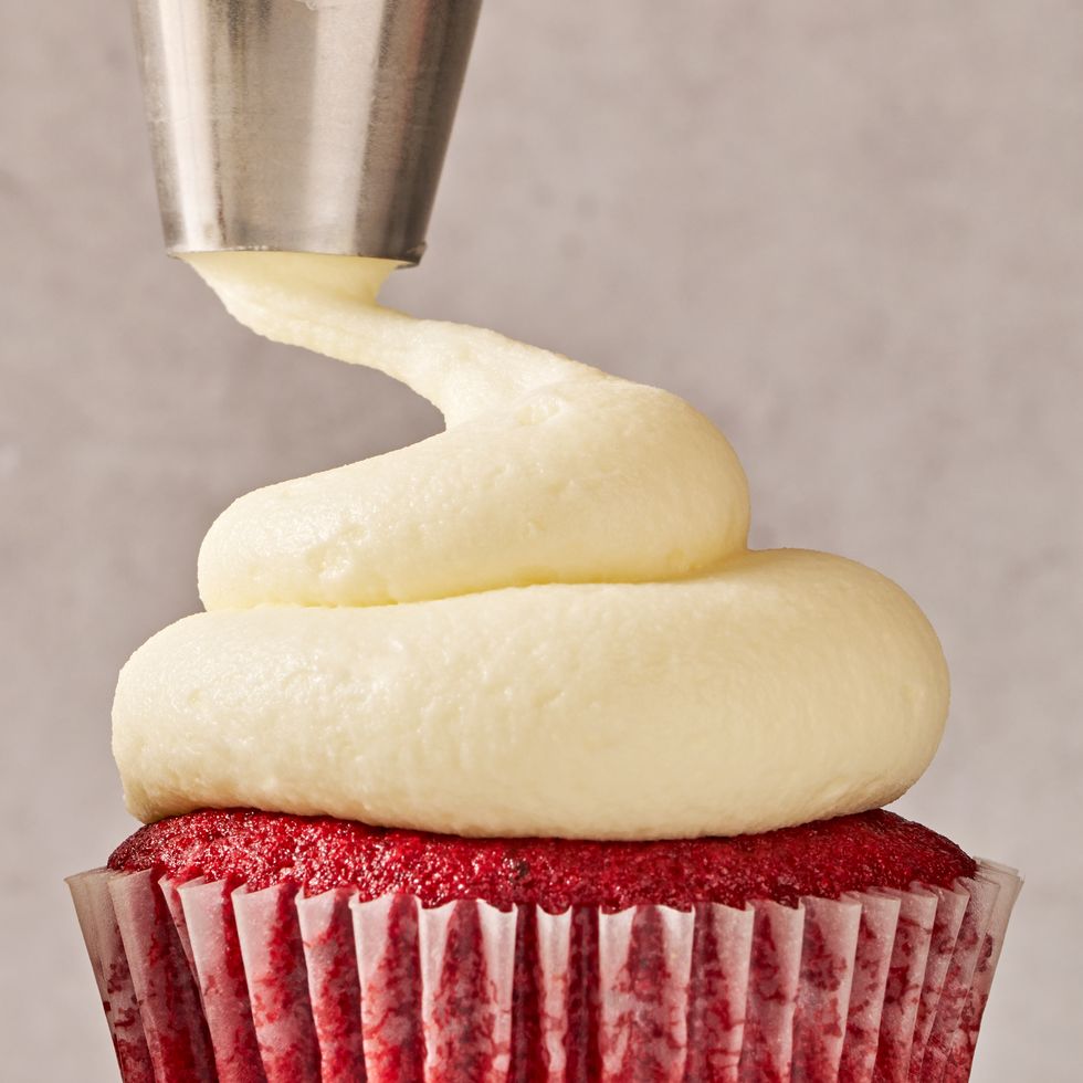a red velvet cupcake with cream cheese frosting on top