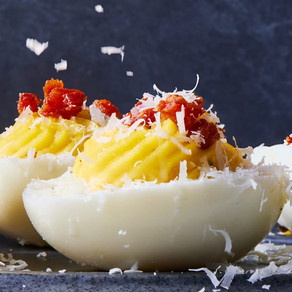 carbonara deviled egg topped with pecorino romano and crispy pancetta