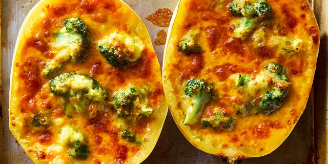 spaghetti squash stuffed with cheesy broccoli cheddar on a sheet pan