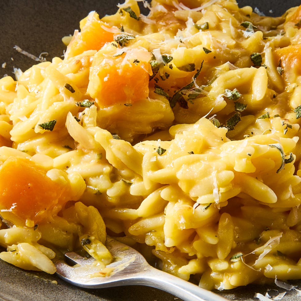 creamy butternut squash orzo on a plate topped with parmesan and herbs