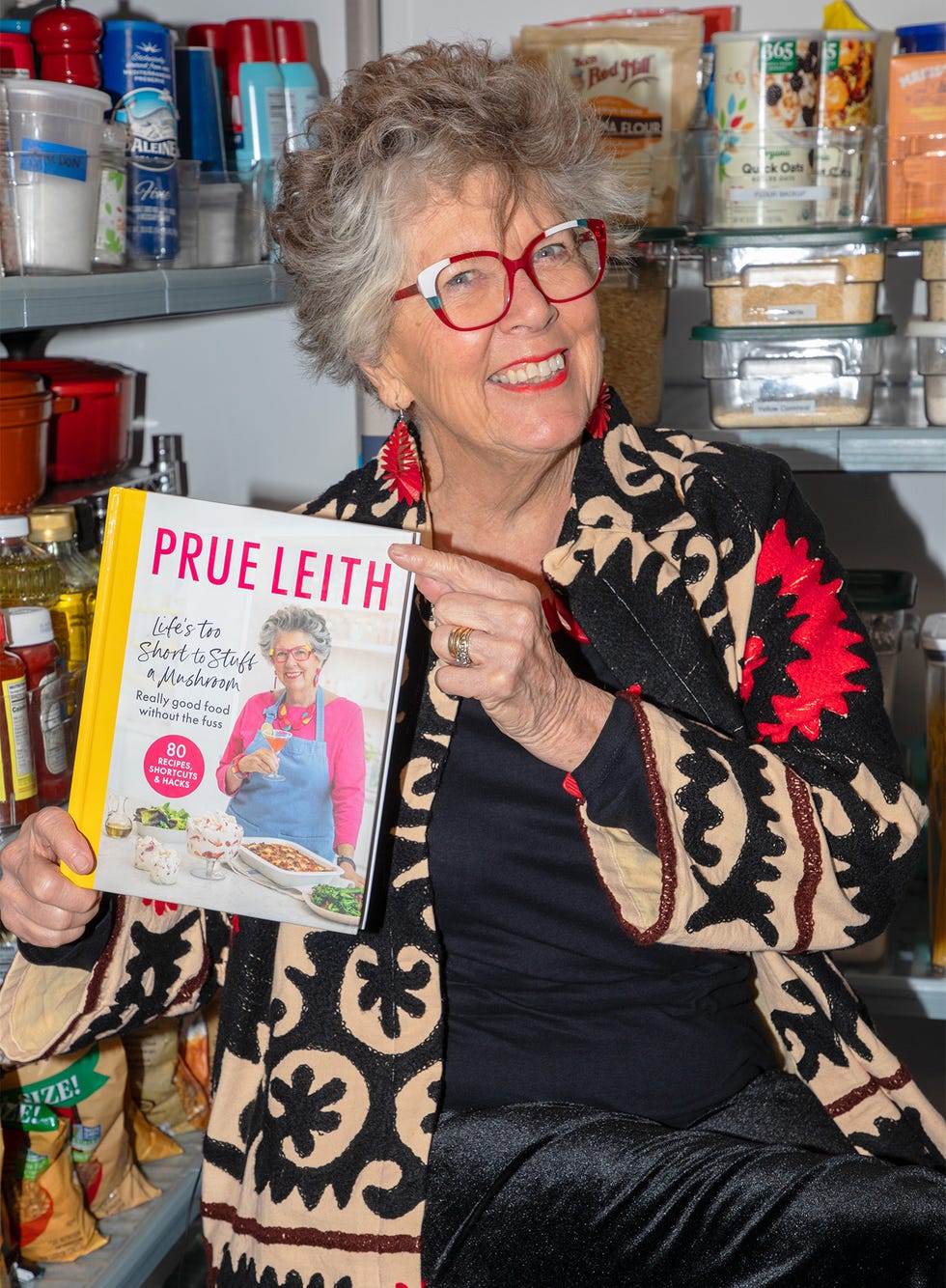 a person holding a cookbook in a kitchen setting