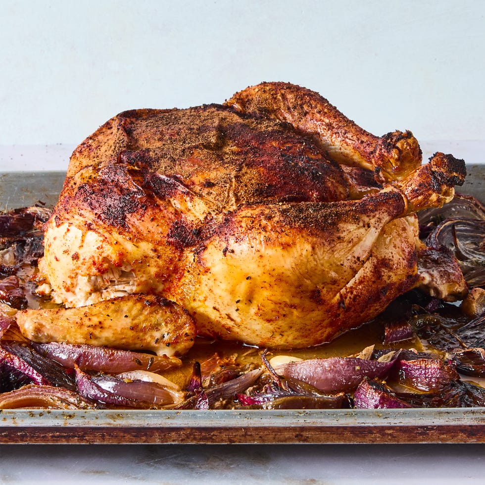 paprika dusted chicken roasted on a bed of herby sliced red onions and whole garlic cloves then topped with an umami rich, spoonable sauce made from chicken fat roasted, charred onions, butter, sweet white vinegar, and crushed red pepper