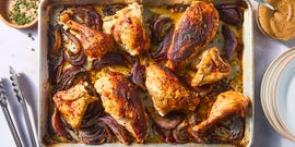 paprika dusted chicken roasted on a bed of herby sliced red onions and whole garlic cloves then topped with an umami rich, spoonable sauce made from chicken fat roasted, charred onions, butter, sweet white vinegar, and crushed red pepper