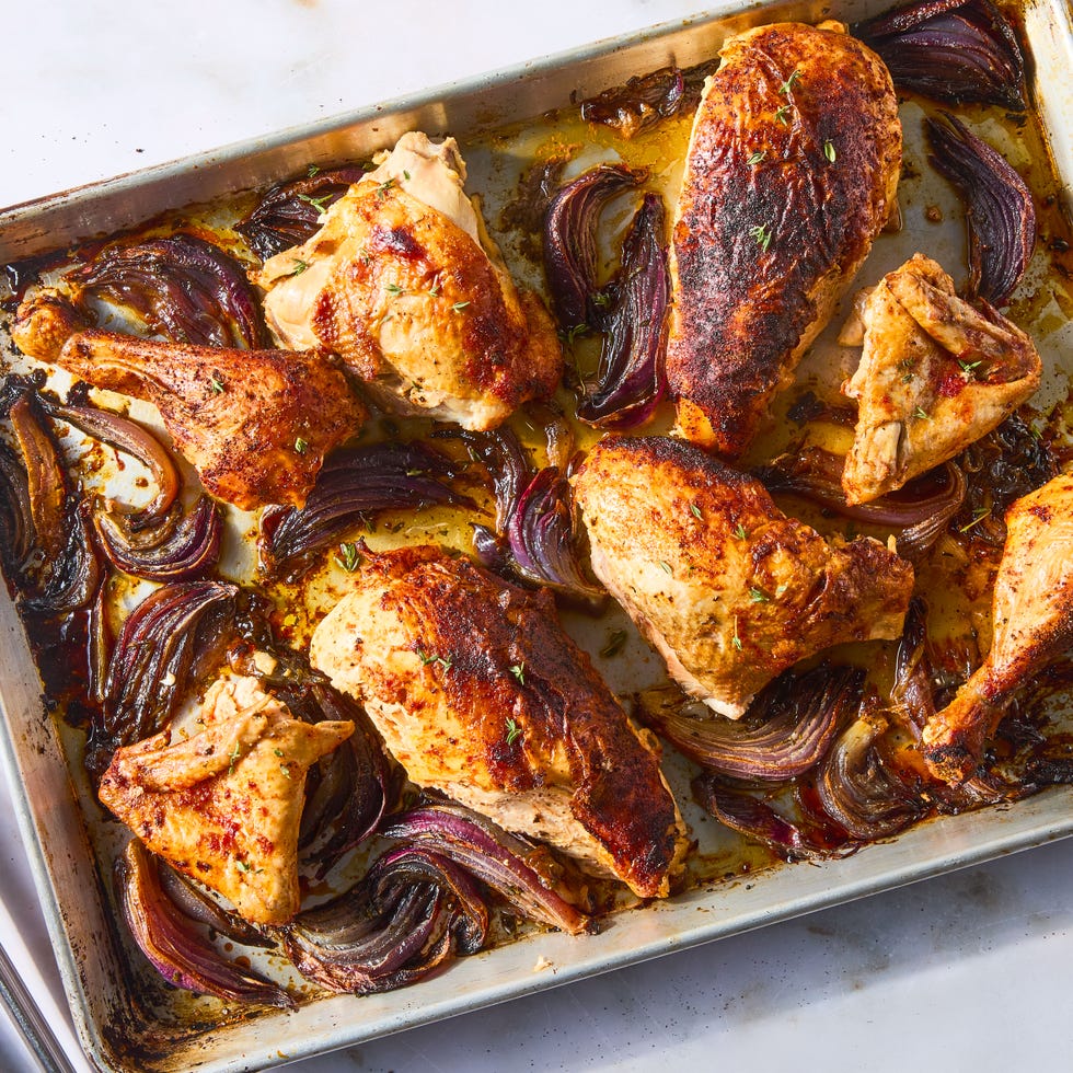 paprika dusted chicken roasted on a bed of herby sliced red onions and whole garlic cloves then topped with an umami rich, spoonable sauce made from chicken fat roasted, charred onions, butter, sweet white vinegar, and crushed red pepper