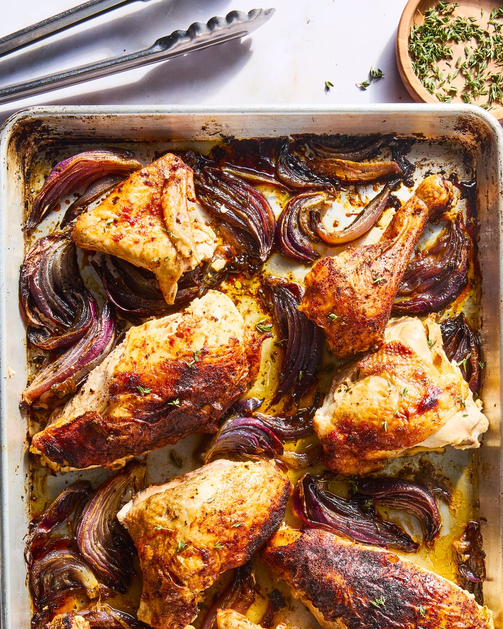 paprika dusted chicken roasted on a bed of herby sliced red onions and whole garlic cloves then topped with an umami rich, spoonable sauce made from chicken fat roasted, charred onions, butter, sweet white vinegar, and crushed red pepper