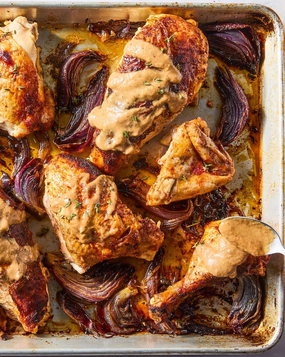 paprika dusted chicken roasted on a bed of herby sliced red onions and whole garlic cloves then topped with an umami rich, spoonable sauce made from chicken fat roasted, charred onions, butter, sweet white vinegar, and crushed red pepper