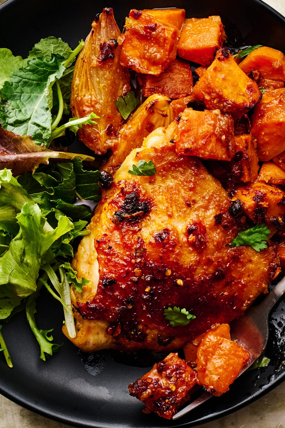Sheet Pan Miso Chicken & Sweet Potatoes bone in chicken thighs, sweet potatoes, and shallots get smothered with miso chili sauce and baked until the sweet potatoes are tender and caramelized and the chicken is juicy and golden brown