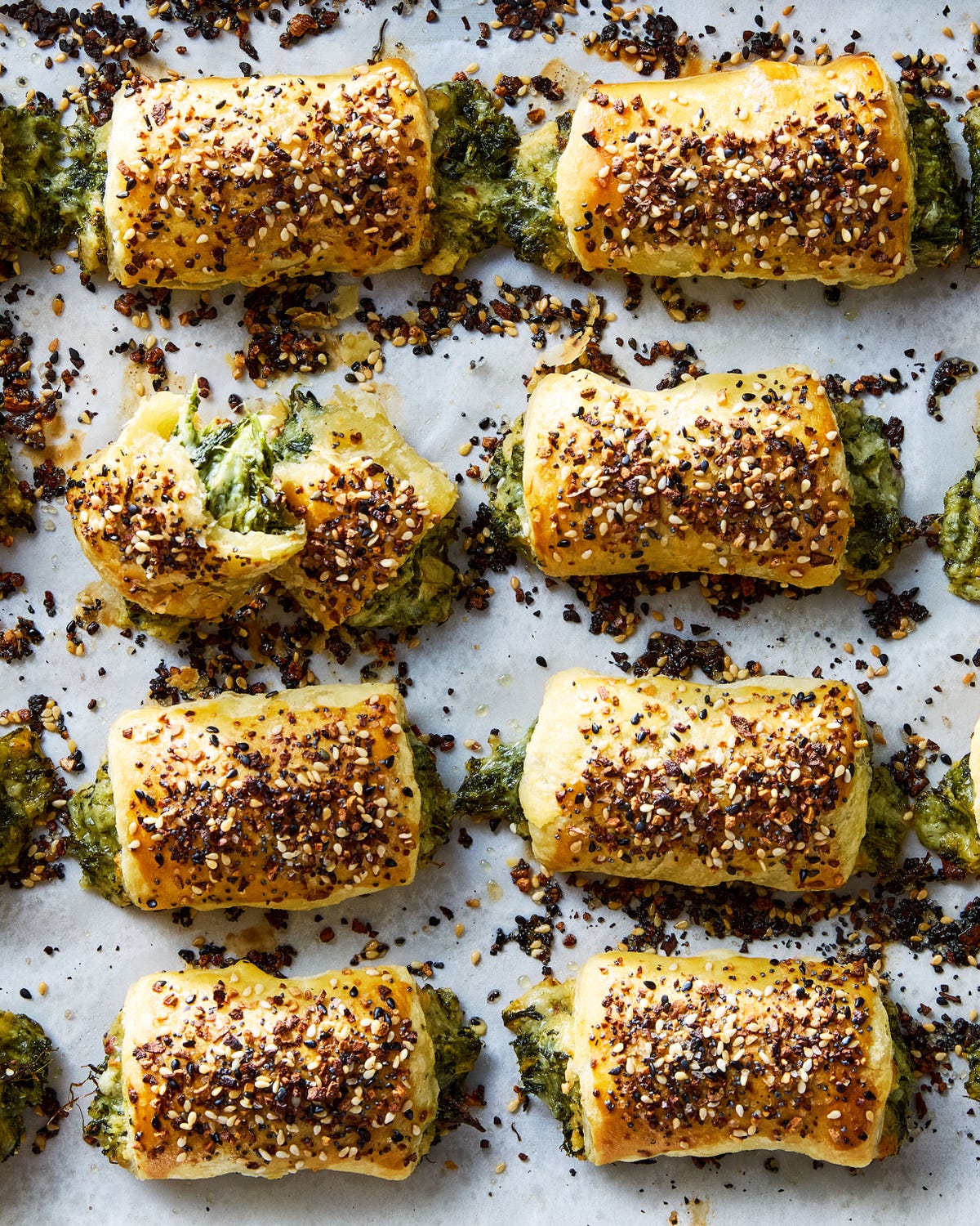 chopped spinach, marinated artichokes, and three types of cheese rolled into flaky puff pastry, topped with everything bagel seasoning, and baked until golden brown